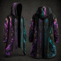 Front and back views of a hooded longline robe or cloak with a black base and vivid cosmic mandala print in purple, pink, teal, and blue, shown on a dark studio background.