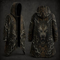 A hooded longline coat shown from the front and back on a dark studio background. The coat features an intricate black and dark gray gothic design with a large snarling wolf face on the back, ornate geometric patterns, and icy textured details in gray and gold.