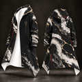 A long hooded coat shown from the front and back on a dark studio background. The outer fabric has a black, white, and gray marble-like pattern with scattered gold flecks and a few dark red accents.