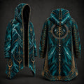 A hooded long coat shown from the front and back on a dark studio background. The garment has a teal and black marbled pattern with ornate gold geometric and celestial line art, including crescent moons and circular symbols.