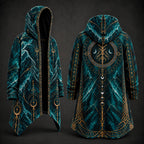 A hooded long coat shown from the front and back on a dark studio background. The garment has a teal and black marbled pattern with ornate gold geometric and celestial line art, including crescent moons and circular symbols.
